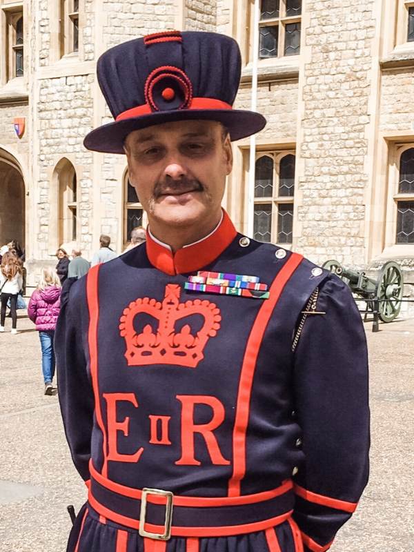 A picture of a man dressed in Yeoman of the guard uniform at the Tower of London a London bucket list destination for many