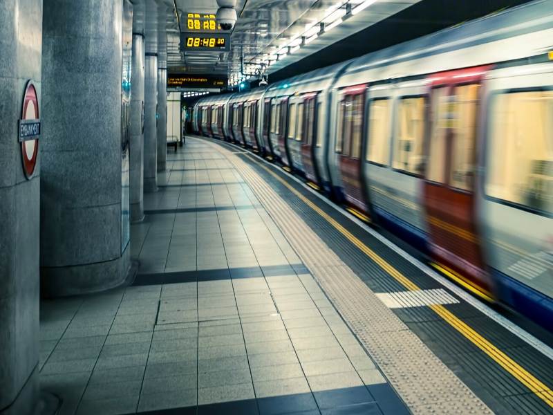 A picture showing a tube train leaving a station on the London Underground