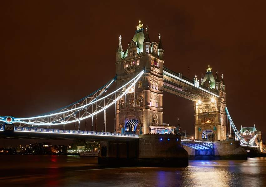 A night picture of Tower bridge with lights along it