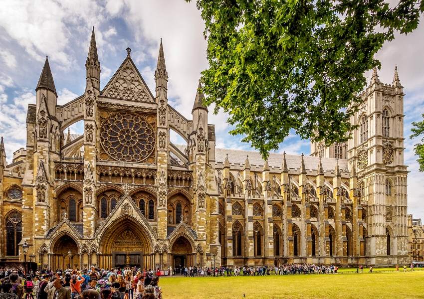 A picture of crowds gathered outside Westminster Abbey a London bucket list place to visit for many.