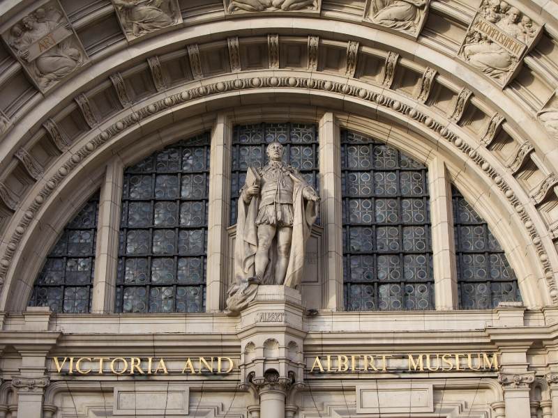 A photo of a statue and a sign for the Victoria and Albert Museum in London