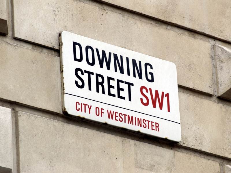 A picture of the street sign for Downing Street in London