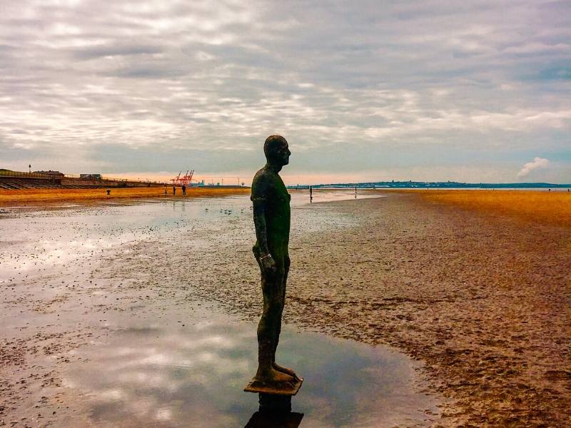 A picture of one of Anthony Gormley's statues at Crosby Beach one of the recommended places to visit in North West England