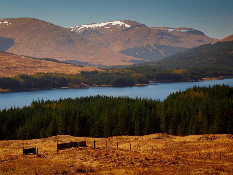 A picture of Loch Ness in Scotland with snow on the mountains in the background