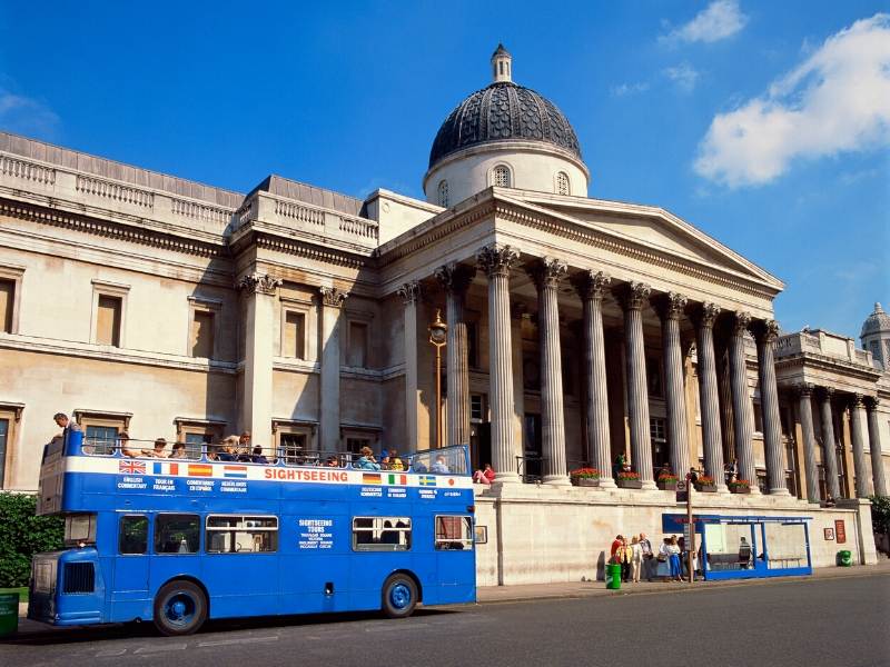 A picture of a blue tour bus outside the National Gallery in London