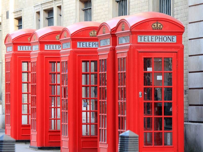 A row of red phone boxes in London