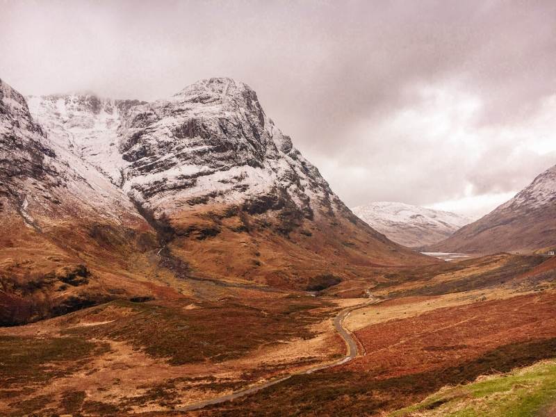 A valley with snow capped mountains