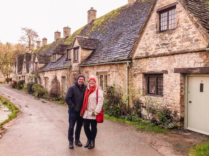 Couple standing in front of Arlington Row in Bibury.