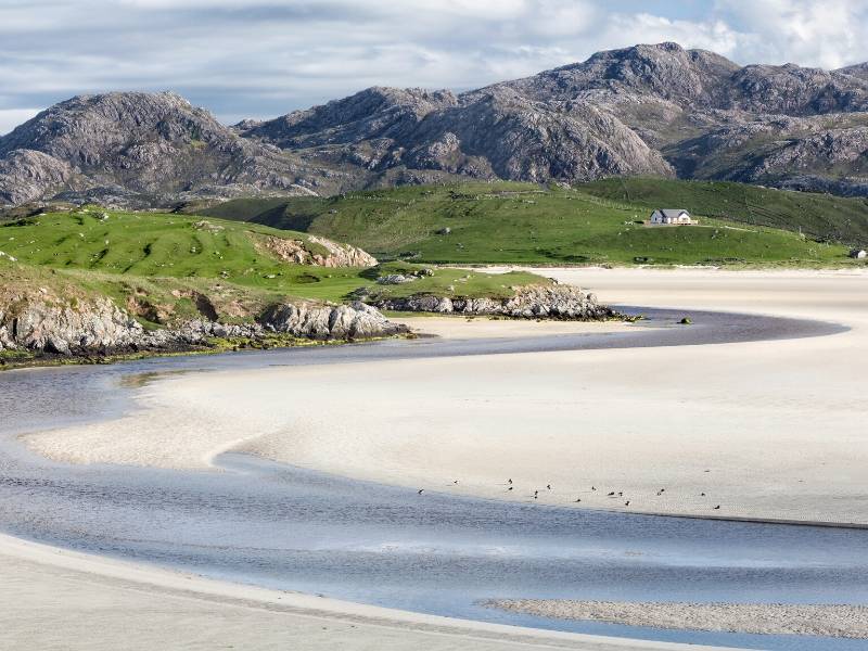 A beach with hills in the background