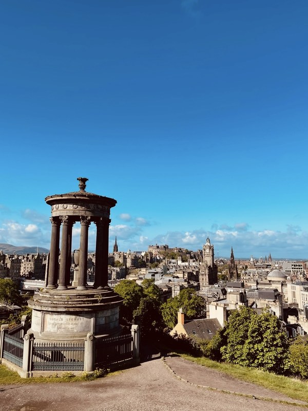 The Dugald Stewart Monument on Calton Hill with Edinburgh Castle in the distance