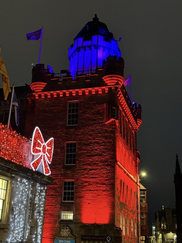 The Outlook Tower at Camera Obscura and World of Illusions in Edinburgh lit red and blue at night