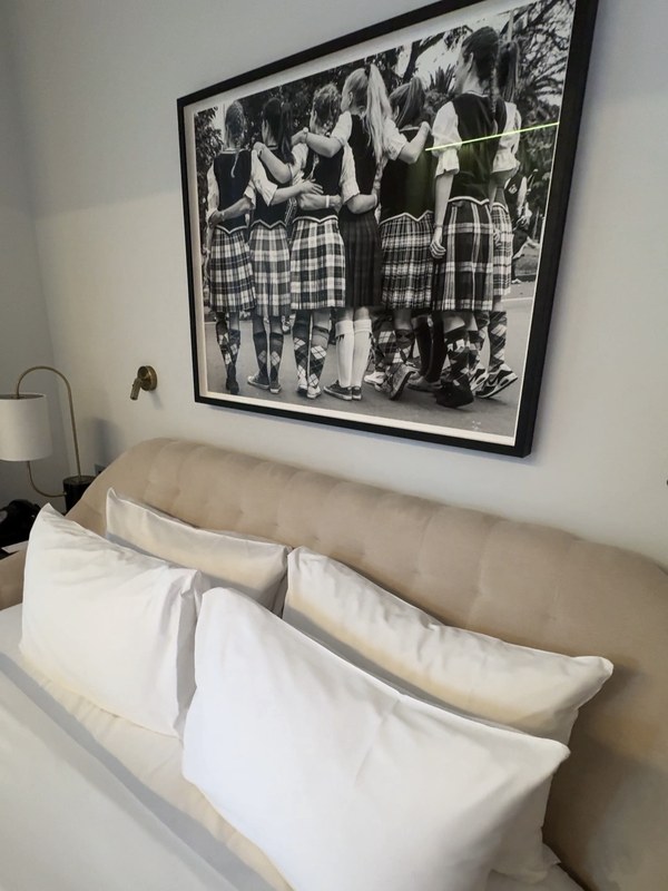 A Chamber room at Virgin Hotels Edinburgh, with a large black and white photograph of girls in kilts above the bed