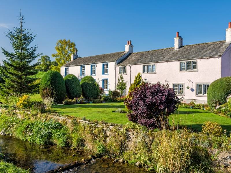 Pretty pink houses near a stream in Caldbeck