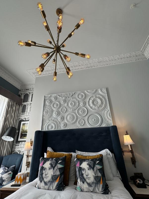 a chandelier above a bed