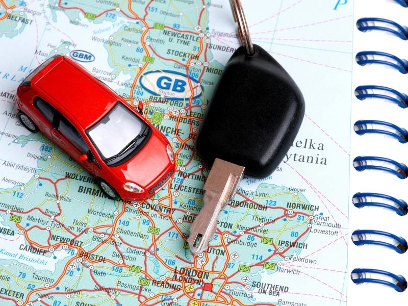 A map of England with a toy car and car keys on it