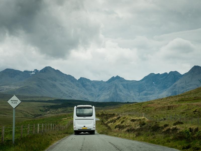 Coach heading towards hills in Scotland