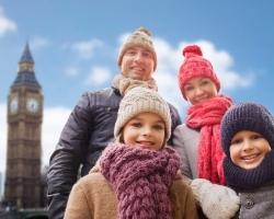 Family in London England smiling in front of Big Ben