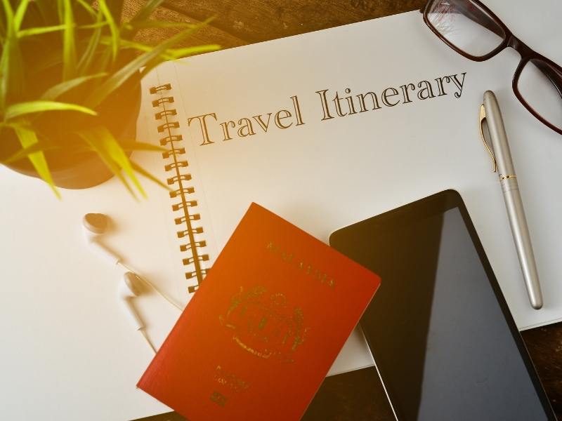 Travel itinerary for a UK trip planner with phone and a pen