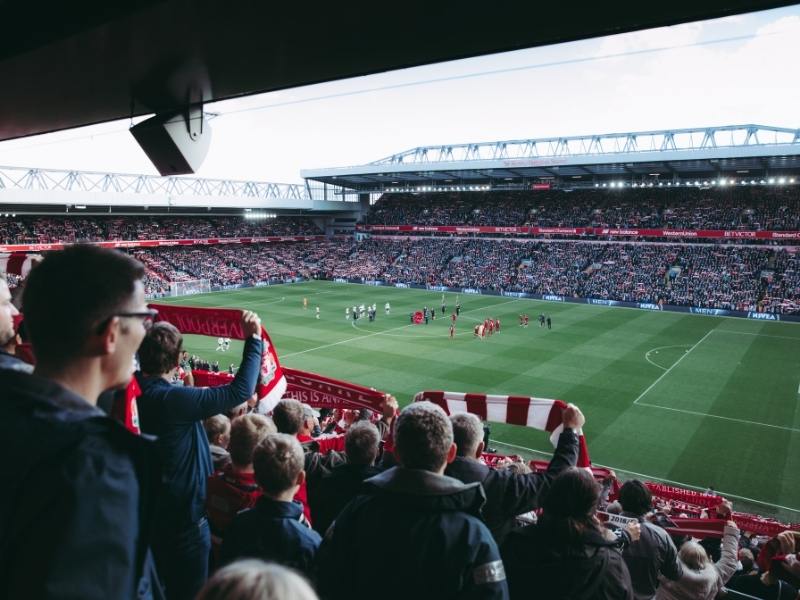 Anfield football club and people watching a match