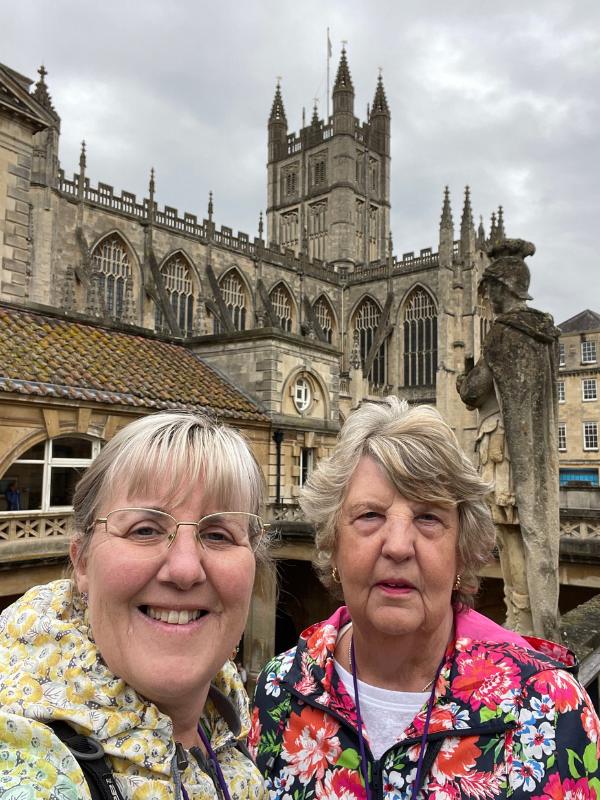 two women taking a selfie in front of a building