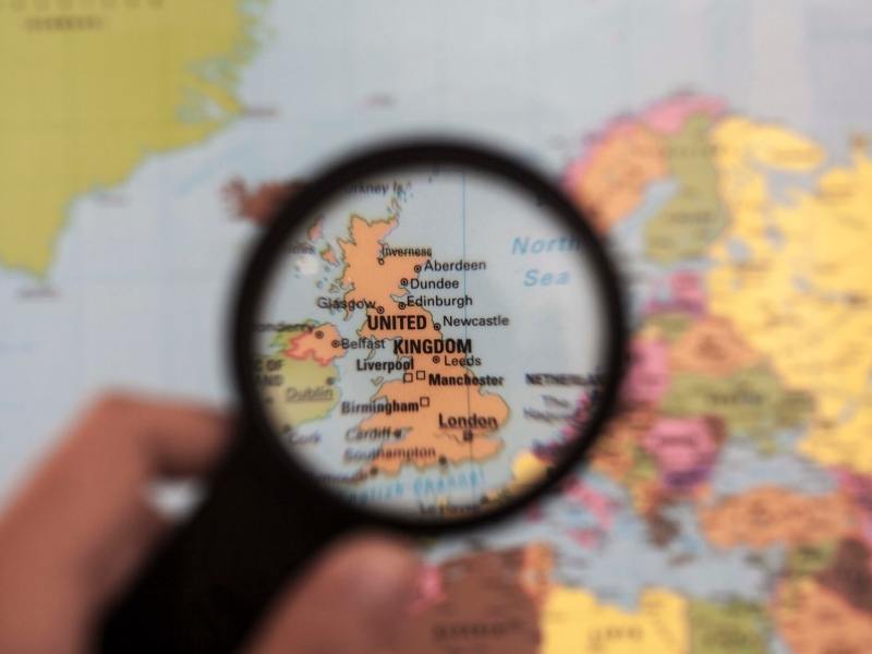 UK map under a magnifying glass as seen in many UK Travel Books.