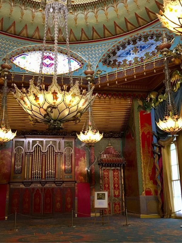 Chandeliers and red walls of the Music Room inside the Royal Pavilion, Brighton