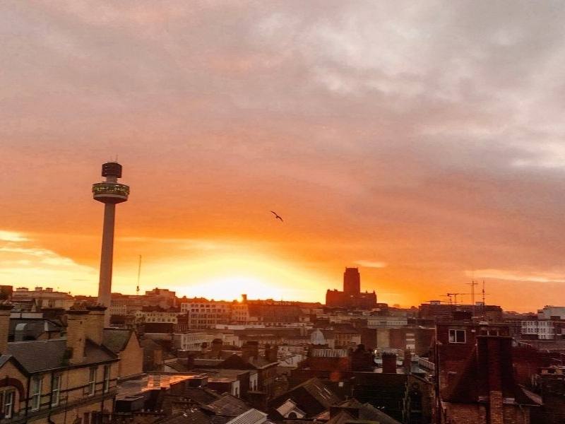 A picture of Liverpool's radio tower and city skyline at dusk