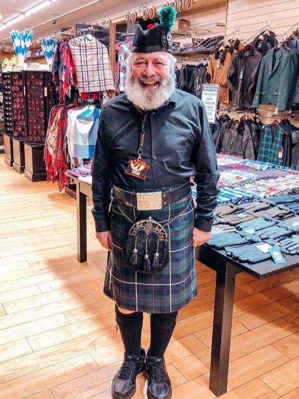 Man in a kilt in a shop in Edinburgh.