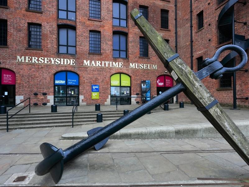 A sign for The Merseyside Maritime Museum in Liverpool and an anchor.