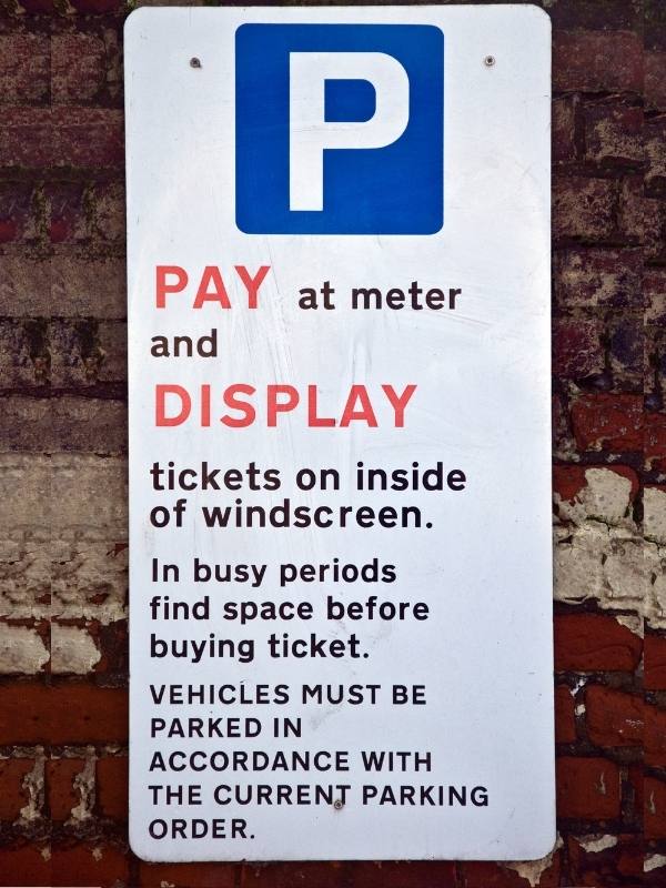 Parking signs such as this one are important to take note of when renting a car in the UK.