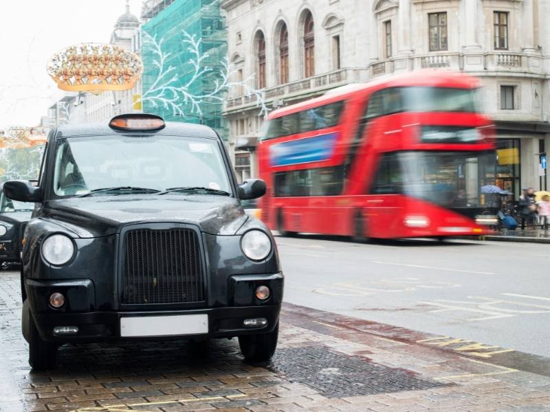 London cab with red bus in the background/