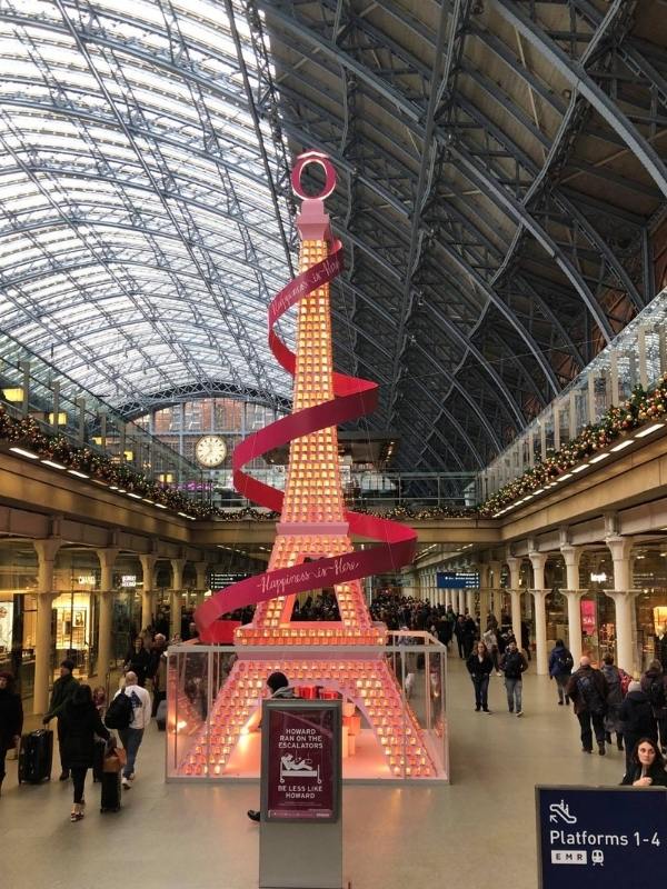 London St Pancras station with a miniature Eiffel tower lit up for Christmas.