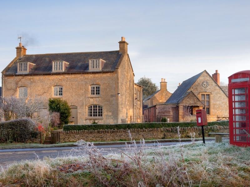 Cotswold villages with frost on the ground and a red phone box.