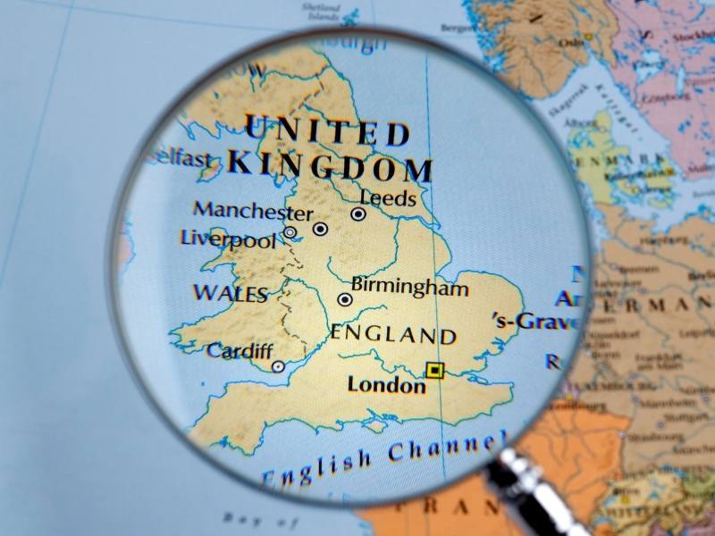 UK map under a magnifying glass.