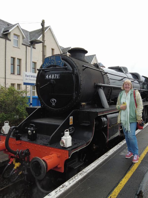 Tracy Collins standing next to the Jacobite train in Fort William.