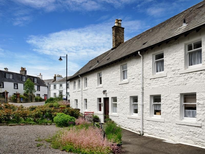 A row of white cottages in Kirkcudbright in Scotland.