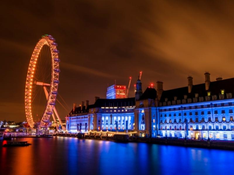 London Eye lit up at night.