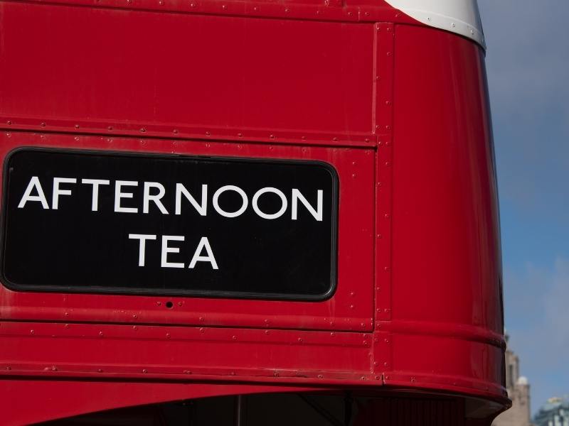 London Red Bus with a sign saying Afternoon Tea.