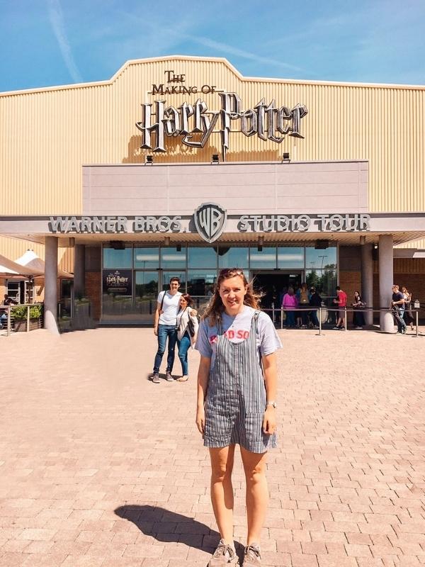 Girl standing in front of Harry Potter studios in London.