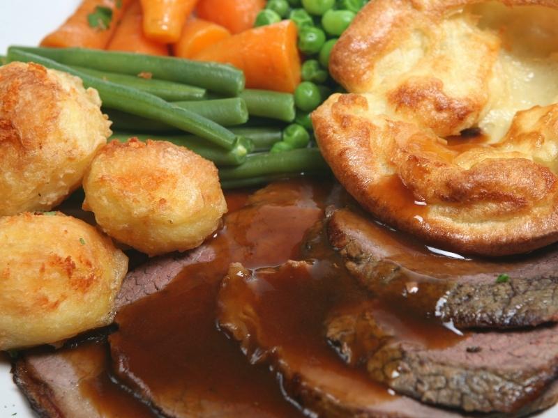 Roast dinner with Yorkshire puddings and gravy.