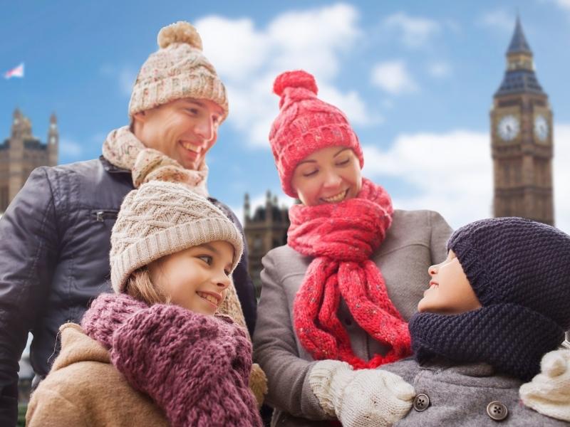 Family wrapped up for winter in front of Big Ben in London.