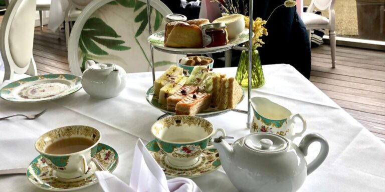 Table laid for afternoon tea with teapot and food at the Orangery Kensington Palace