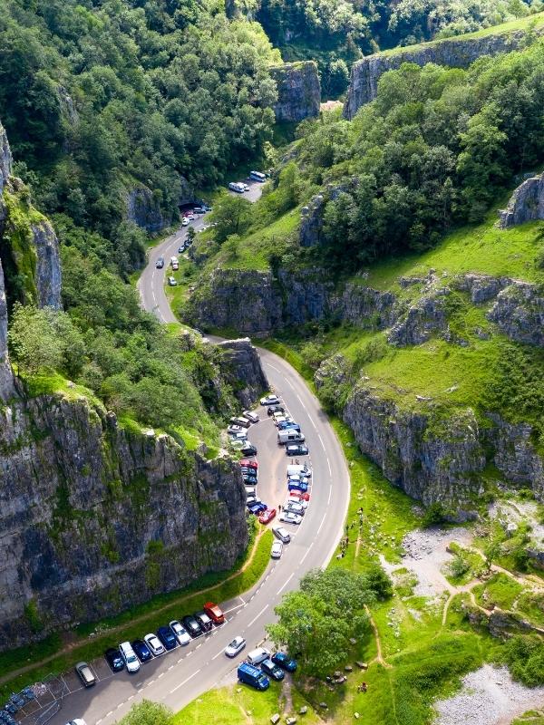 a ravine with cars parked at the bottom