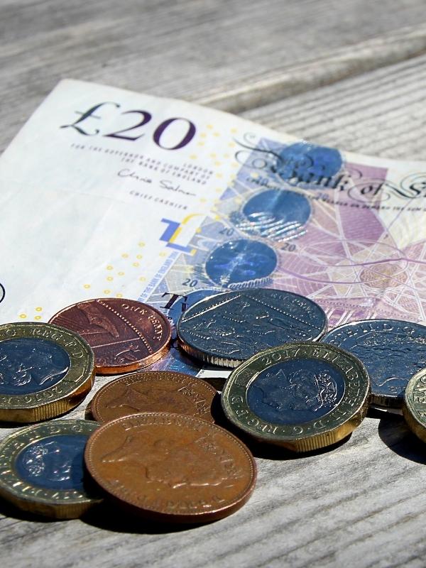 A pile of UK coins and notes.