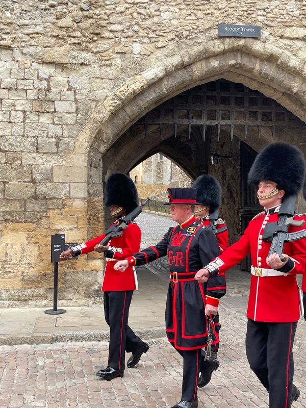 Yeoman warder escorted by the King's Guard at the Tower of London.