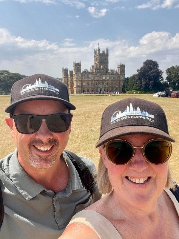 Tracy and Doug Collins standing in front of Highclere Castle.