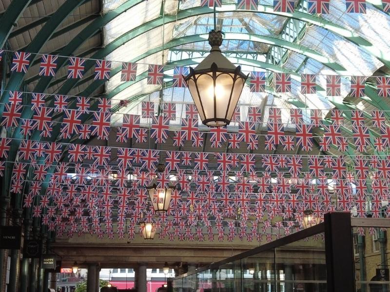 Union Jack flags in lines hanging from a ceiling at Covent Garden London.