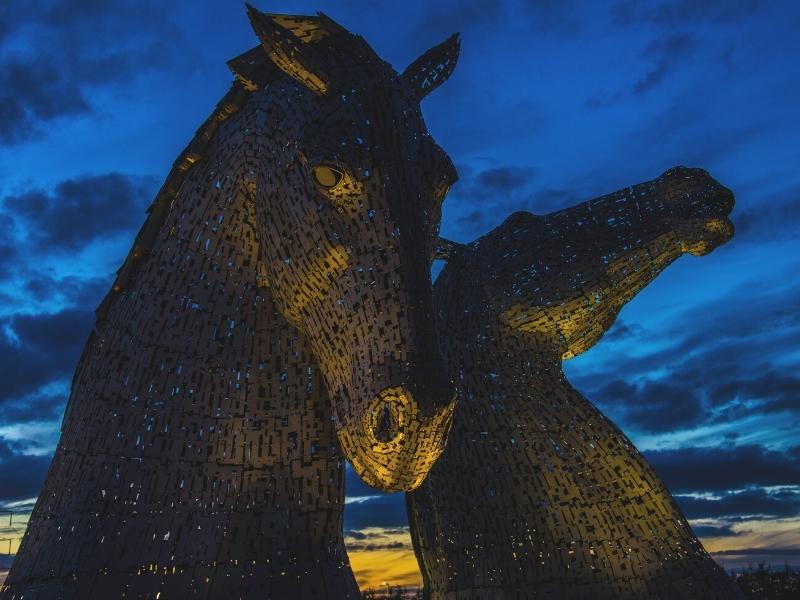 The Kelpies lit up at night.