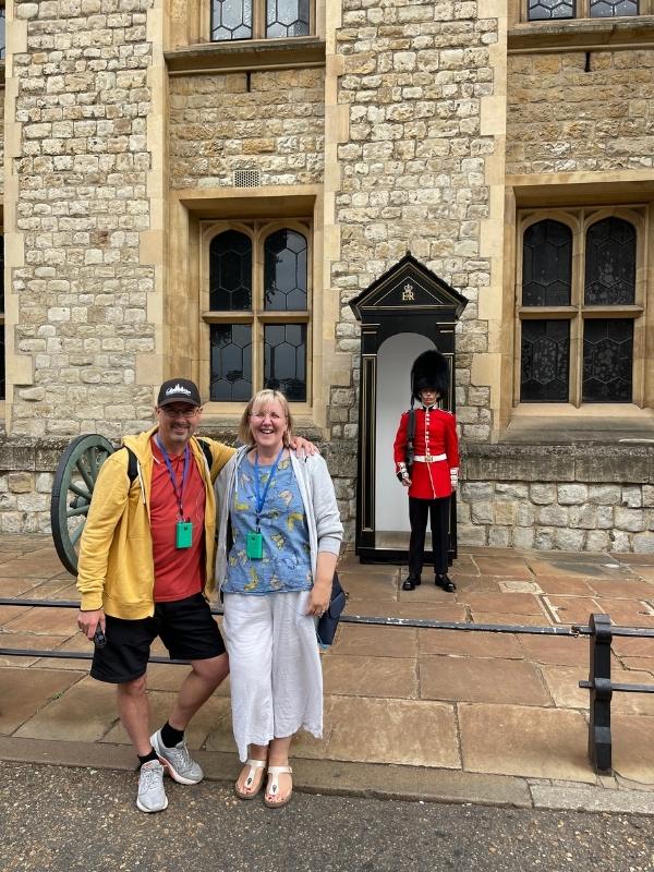 A couple standing in front of a King's Guard at the Tower of London on one of the best tours in London.