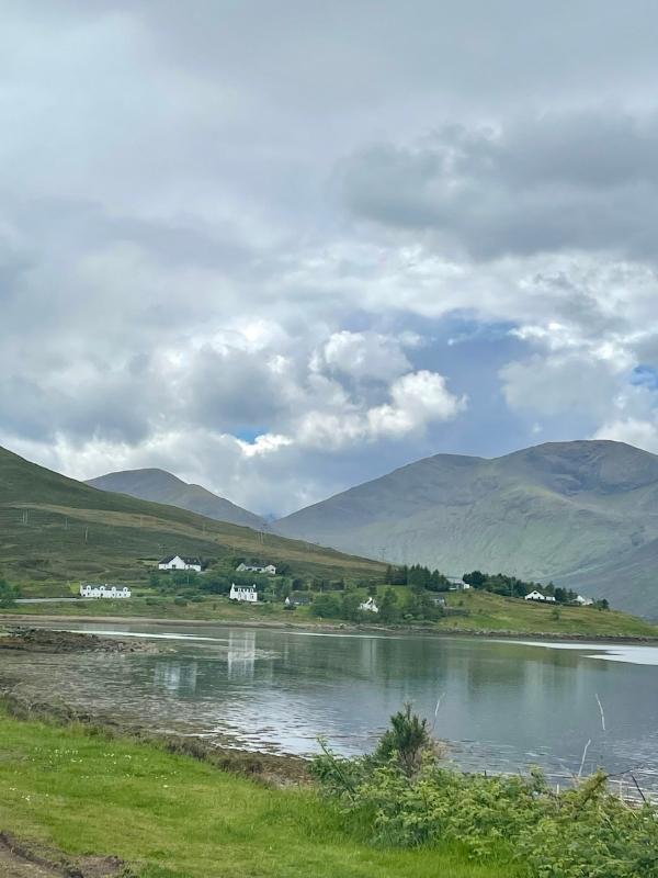 Green hills and a loch in Scotland.